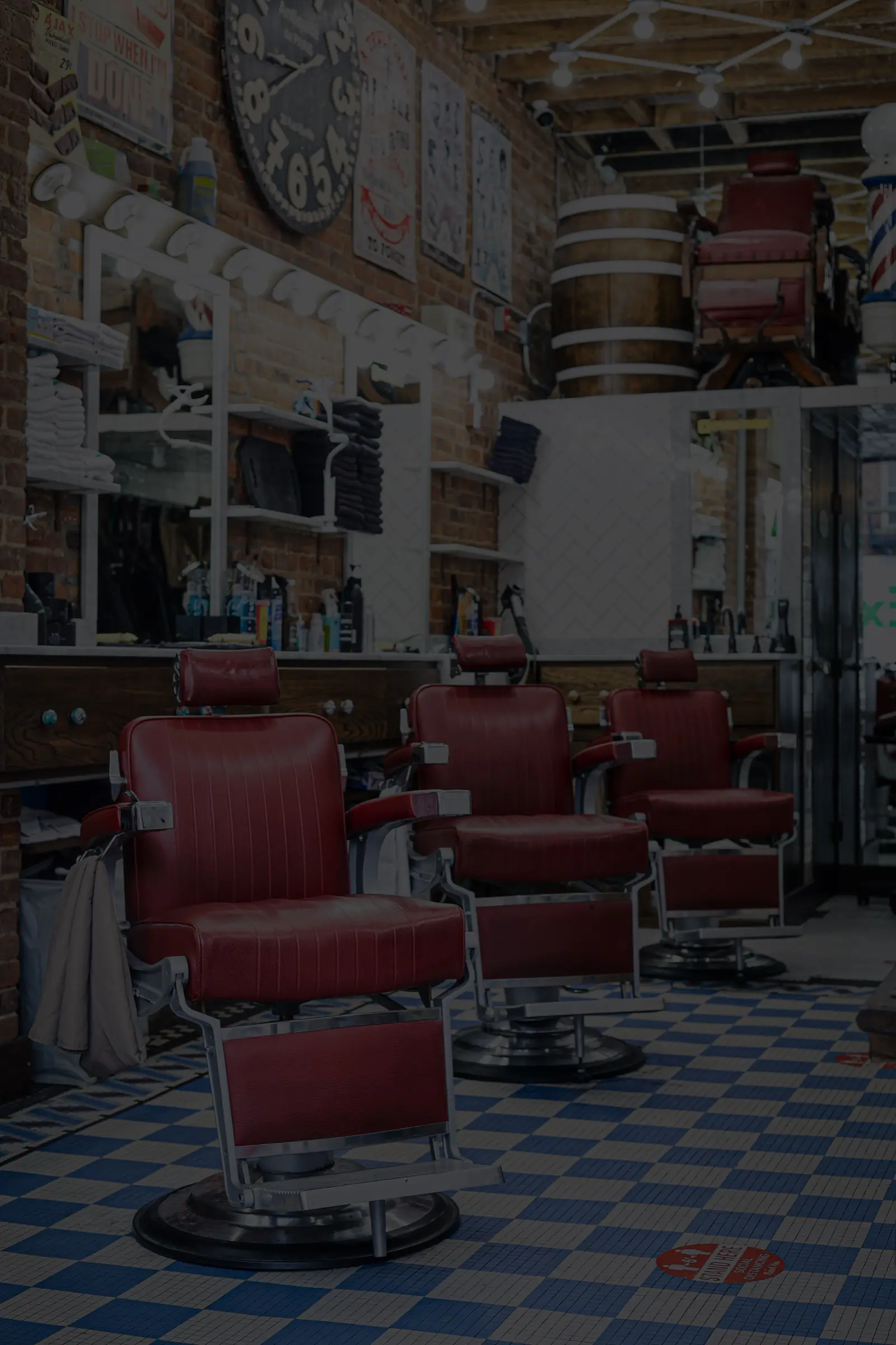 Red vintage barber chairs at Groomers & Pomade in Brooklyn