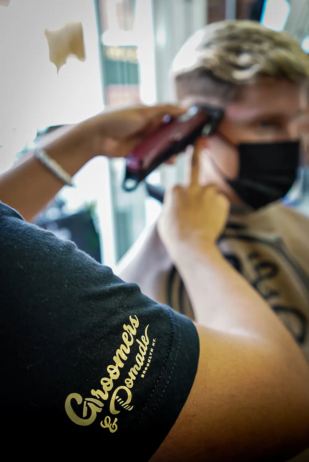 A Groomers & Pomade barber giving a precision haircut