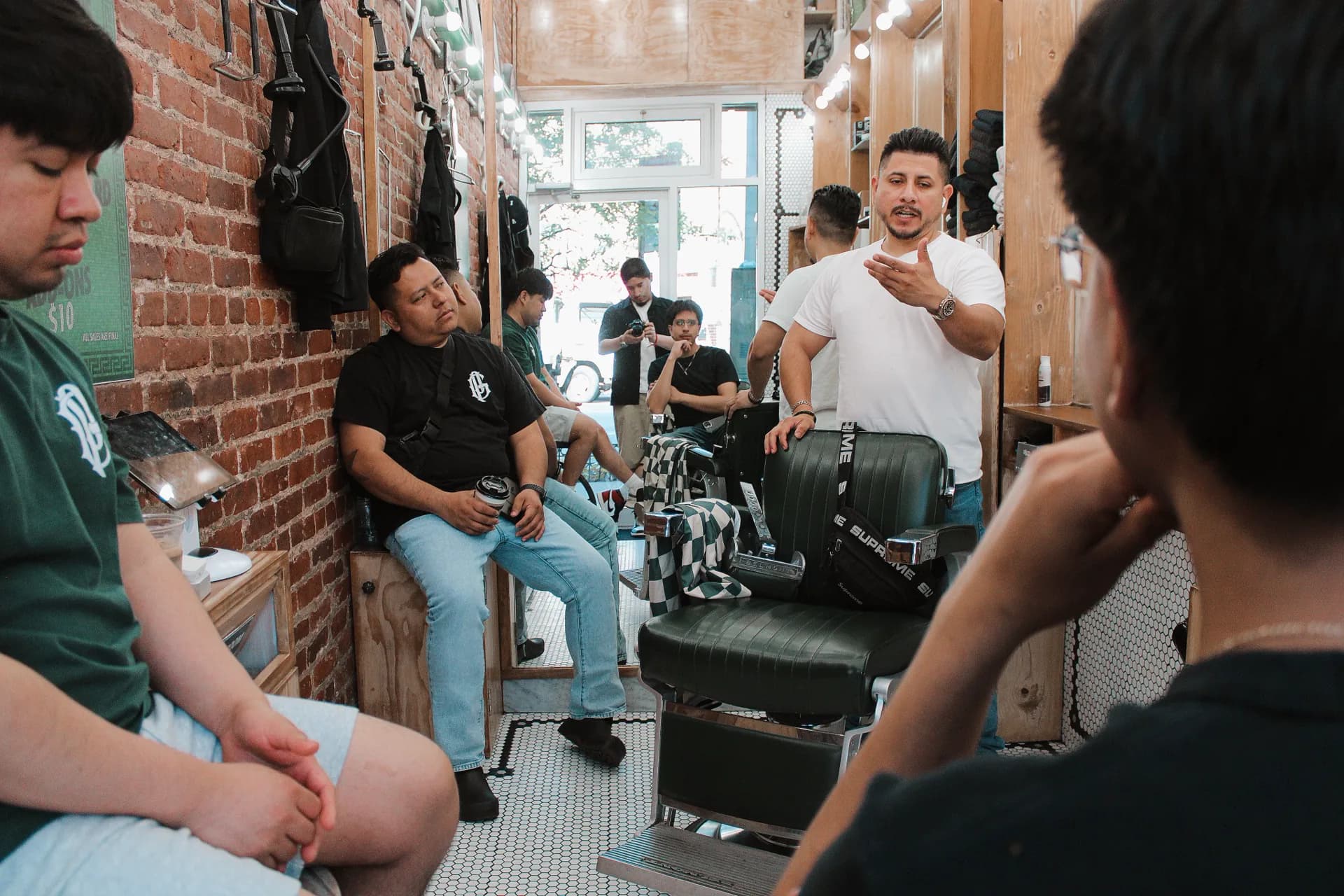The Groomers & Pomade team gathered inside the barbershop